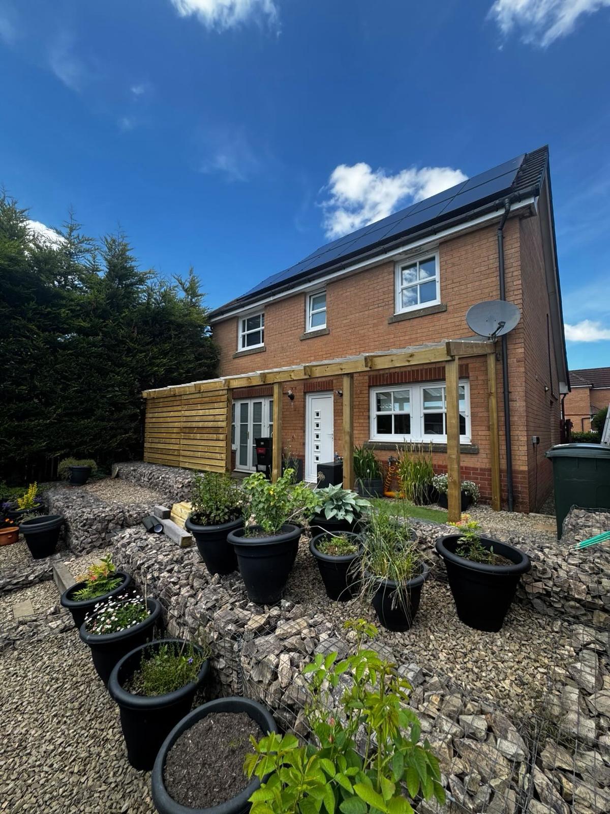 Timber pergola and veranda structure with gravel garden landscaping